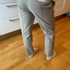 Beige byxa från Tiger of Sweden - Beige byxa från Tiger of Sweden. Byxorna har en klassisk design med pressveck och midwaist passform. Skulle beskriva dom så något mellan Chinos, kostymbyxa och trackpants, otroligt sköna.