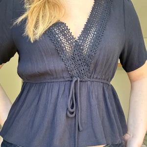 mörkblå topp - mörkblå topp med spetsdetaljer och knyt i midjan. Supersöt sommartopp som endast använts två gånger!