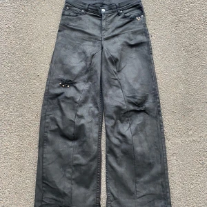 Waxed Baggy Jeans - Black Waxed Painted Baggy Flared Double Back Pocket Jeans with Studs. Custom made! Size 32/34 Waist: 41cm Length: 110cm Leg opening: 31cm