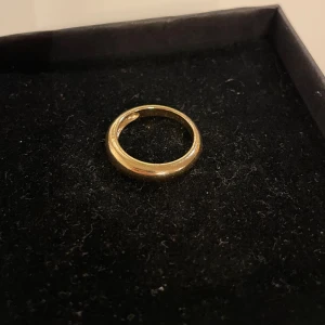 Elegant guldring - Snygg och stilren guldring med en klassisk design. Perfekt för att lägga till en touch av elegans till vilken outfit som helst. Ringen har en slät yta och en rundad form. Inre diameter är ca 18 mm.