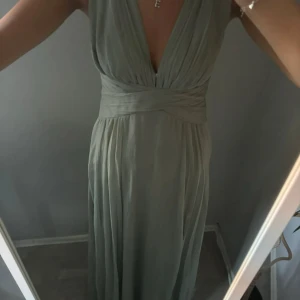 Grön långklänning med omlott - Säljer min gamla balklänning, superbra skick! Korsar i ryggen