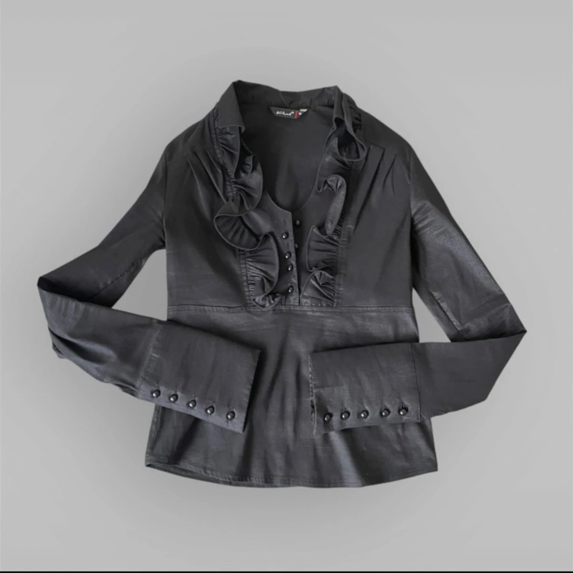 Svart blus med volangdetaljer från kiwi