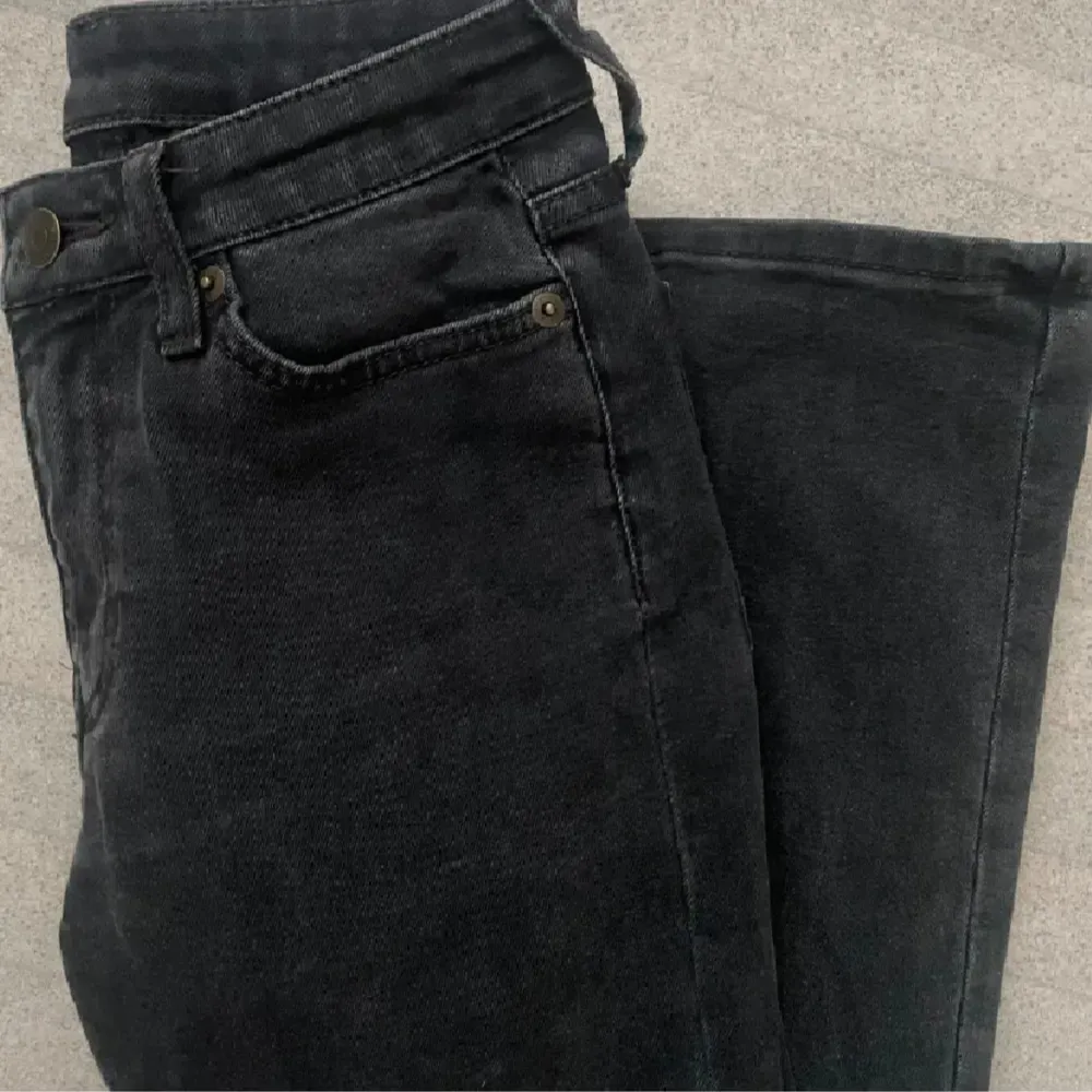 Säljer ett par snygga svarta lågmidjade bootcut jeans i bra skick i storlek 25/32 från Weekday. Perfekta för både vardag och fest!. Jeans & Byxor.