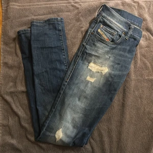 Blå jeans från Diesel - Säljer ett par blå Diesel jeans med slitningar vid benen. Skick 10/10 knappt använda. Strlk w28 L32 känns som w29. Kom dm om ni är sugna.👖🙌🙌