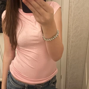 Rosa ärmlös topp - Säljer en söt rosa ärmlös topp i bomull. Perfekt för varma dagar och enkel att matcha med jeans eller kjol. Toppen har en rund halsringning och en bekväm passform.