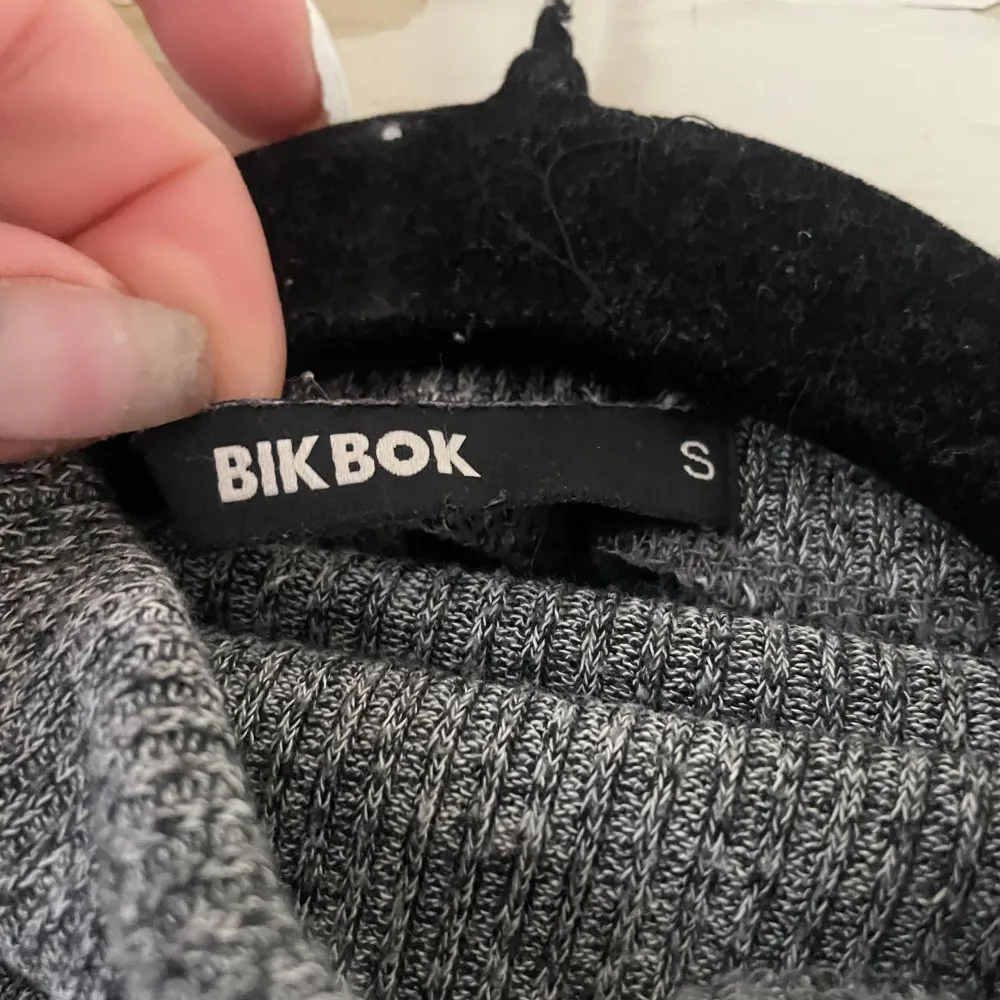 Säljer en supermysig grå stickad tröja från BikBok. Den har en enkel och stilren design med långa ärmar och en bekväm passform. Perfekt för höst och vinter när du vill hålla dig varm och snygg. Tröjan är i storlek S och passar perfekt till både jeans och kjol.. Tröjor & Koftor.