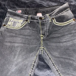 True religion jeans gråa med gul och vit söm - True religion jeans i strlk 34 i bra skick skriv för mer information 