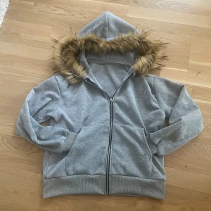 Grå hoodie med fur🦁🔥 - Säljer denna asfeta hoodie. Askönt material på både hoodien och pälsen. Den är 63 lång och 53 bred, jag är 1.83 och har på den i bild 3. Pris kan diskuteras 