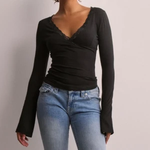 Svart långärmad topp med spetsdetaljer - Jätte fin tröja från Nelly som aldrig används! Nyskick 