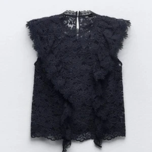 Mörkblå spetsblus från Zara - Mörkblå spetsblus med volangdetaljer från Zara. Blusen är ärmlös och har en rund halsringning. Andvänd fåtal gånger💗