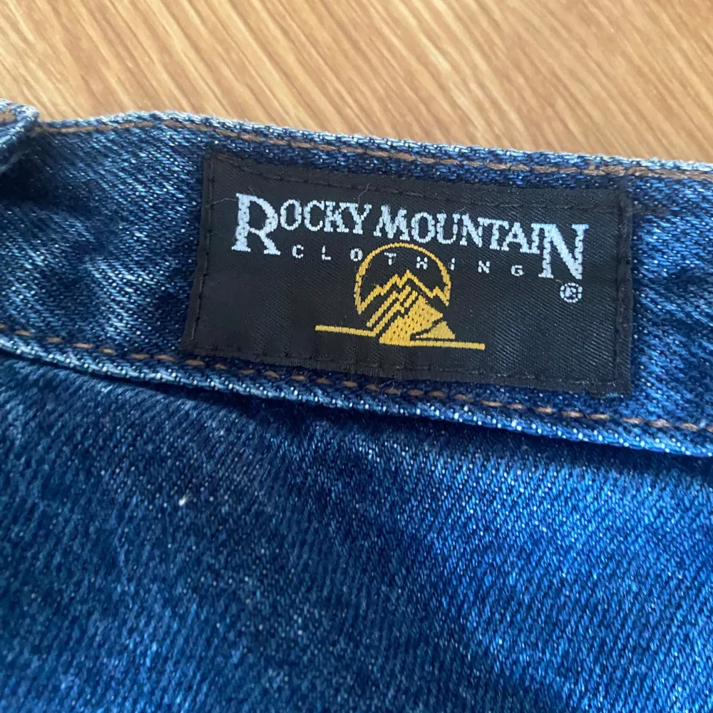 Coola jeans från Rocky Mountain clothing co. med unika detaljer! Köpte secondhand för ca 500 men aldrig använt då de var för små. Står ingen storlek men skulle säga att de är ca 32. . Jeans & Byxor.