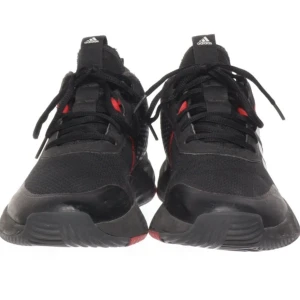 Svarta sneakers från Adidas - Snygga svarta sneakers från Adidas med vita ränder och röda detaljer. Skorna har en sportig design med snörning och en bekväm sula. Perfekta för en aktiv livsstil.