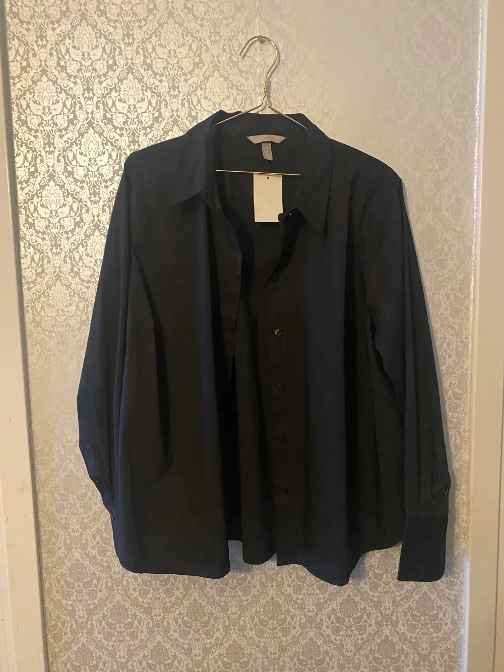 A black brand new shirt in size XL from H&M in Portugal. It has never been used and still have the price tag on. It’s from the women section    Measurements taken laying flat:  Chest: 61cm  Waist: 62cm  Arm: 17cm  Length: 66cm . Skjortor.