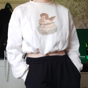 Kort Sweatshirt med tryck - Säljer en jättefin kort sweatshirt med tryck. Färgen är offwhite. Det står "Mixed feelings" på trycket. Jättefint skick, sparsamt använd. Går att dra oin så att den sitter tightare i midjan, men går också att ha lös (se bild 3). Skriv för mer info🌸