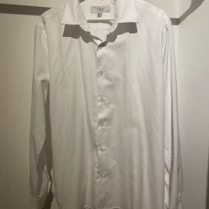 Vit Erla skjorta - Säljer en vit Erla skjorta i storlek XL eller 43/44. Passar även som L då den är slim fit. Inga synliga fel på den. Passar perfekt med kostymen! Skriv för fler bilder eller eventuella funderingar🤙🏼