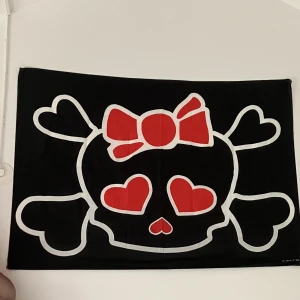 Svart hello-kitty döskalle (flagga) - Cool/snygg flagga som jag köpte i en punk butik. Tycker inte flaggan passar in i mitt rum och jag har också precis köpt en ny flagga jag vill sätta upp där. Flaggan är  92x133 cm. 