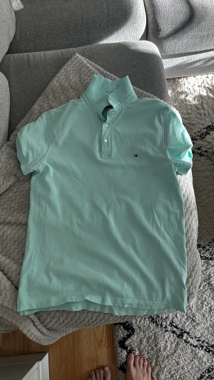 Pikétröja  - Säljer en ljusgrön Tommy Hilfiger piké. Knappt använd. Storlek L