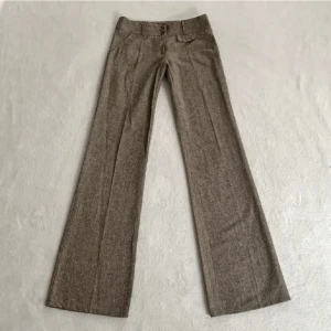 Bruna kostymbyxor - Lågmidjade utsvängda kostymbyxor. Jag är 172 och dessa funkar bra på mig. Midjemått: 70cm Innerbenslängd: 86 cm👖