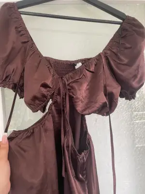 En brun klänning med öppna höfter Använd en gång