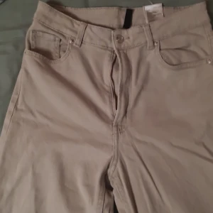 Bige/gråa high-waisted byxor - Byxorna är en blandning av bige och grå. Jag kan inte skicka paket :/ men om due intresserad kan vi träffas i tc.