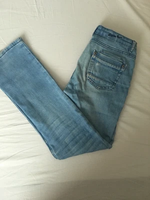 Låg midjade och utsvängda jeans - Passar med vilken tröja som helst, låg midjade, utsvängda,  byxor till barn från åldern 8 till 10.