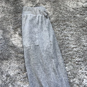 Gråa juicy  - Säljer mina gråa juicybyxor då dom inte kommer till användning. Byxorna är smutsiga längst ner då jag är för kort. Samt ett jätte litet hål i fram fickan. Annars är dom i fint skick.