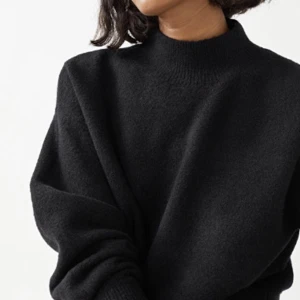 Polotröja från Stories - Stickad tröja med halvpolo, nedhasade axlar och rak passform.  ÅTERVUNNEN POLYESTER  Ribbstickad kring halsringningen, vid ärmslut och i nederkant  Sparsamt använd 