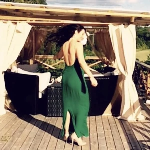 Samsoe långklänning grön strl S - Perfekt till bröllop. Öppen rygg & smala band. Slits där bak. Använd men i bra skick. Kan ha lite skavanker i tyget längst ner, närmast fötterna. Tycker personligen att den är lite större i storleken så den passar även storlek M