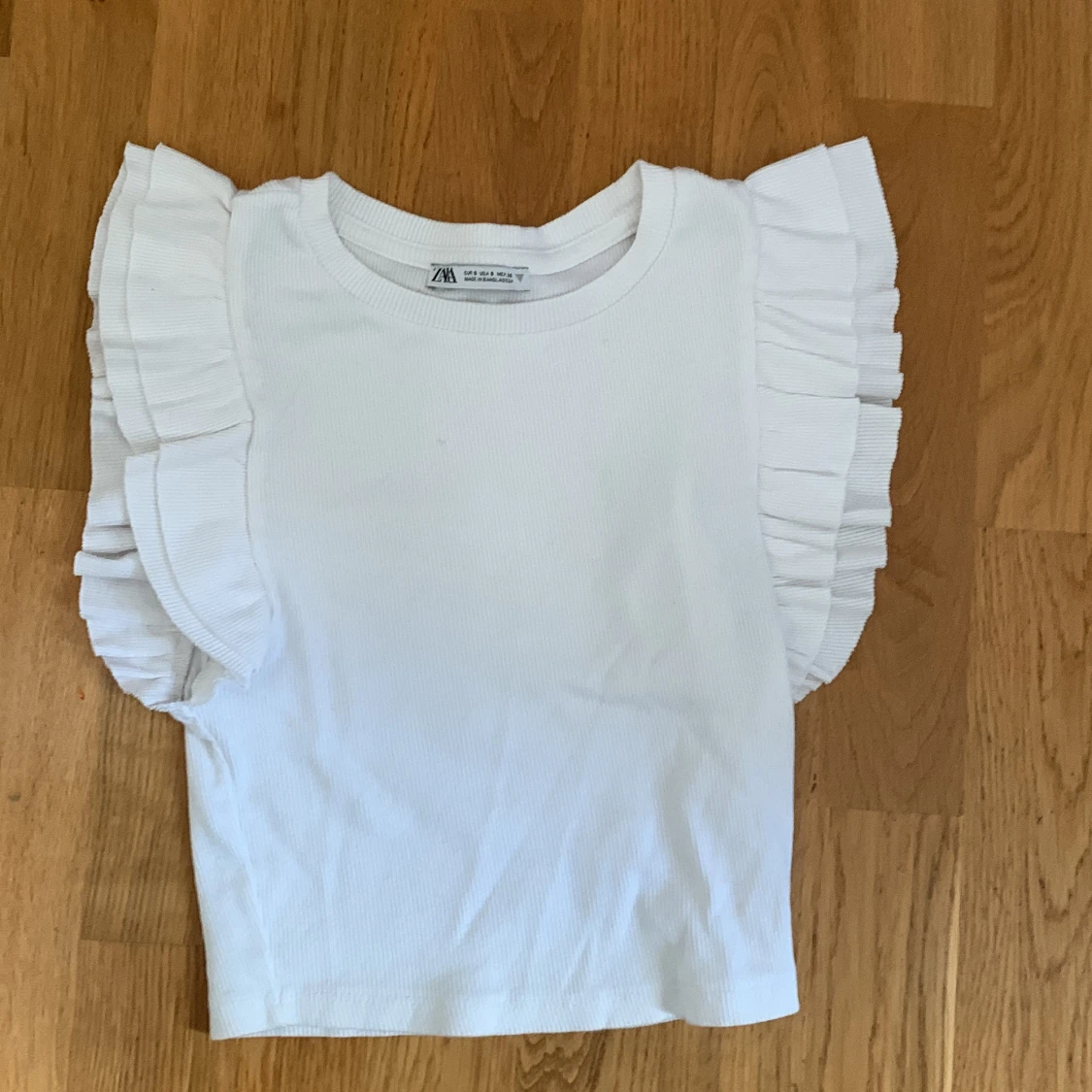 Zara T-shirt med volang på axlarna