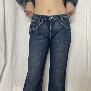 Baggy jeans  - Lowrise Baggy jeans med broderat mönster på fickorna, behövt vika upp dem lite.