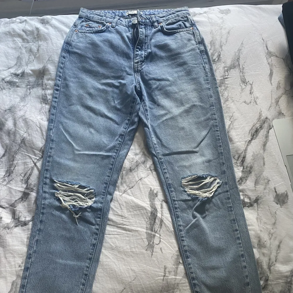 Säljer ett par Jeans med hål från Gina!  Jag skulle säga att det är baggy jeans och rätt så raka nertill.  Innerbenet är 70cm, midjan är 69cm, Använt 1 gång, så väldigt bra skick. Priset kan diskuteras, nypris: 499kr . Jeans & Byxor.