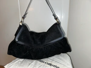 Fendi väska - Rymlig mocka fendiväska med skinndetaljer o signatur fäste på remmen.  Äkthet verifierad av Vestiaire Collectives (kommer med dustbag) men har tyvärr inte kommit till användning.  Har fått fläckar, vilket ska gå bra att tvätta bort.  Skriv för mer bilder!