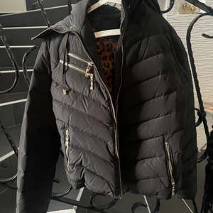 Hollies vinterjacka - svart  - Jag säljer min hollies vinterjacka i färgen svart, det är den perfekta dunjackan till vintern som verkligen lever upp till all förväntning. Jackan har två fickor fram vid höften och två bröstfickor, alla är med guldiga dragkedjor. Det är leopard mönster innifrån och jackan är använt 8-10 gånger. Den är lite liten i storleken men om det är rätt storlek så sitter den helt perfekt. Köpt för 3 499kr men säljs för 2 499kr, pris kan dock diskuteras. Storleken på jackan är 40.