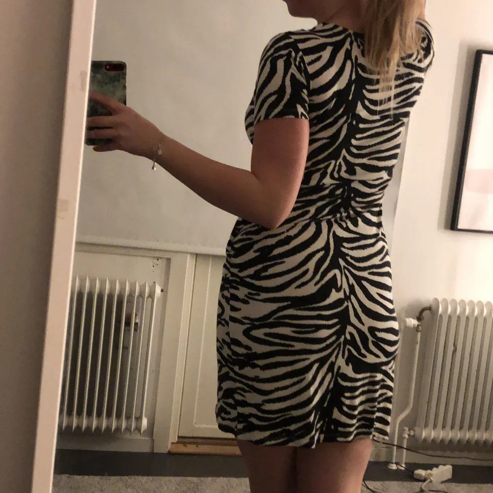 En super skön zebramönstrad klänning som aldrig kommer till användning då jag inte är ett stort fan av mönster, v-ringad och har nån sorts ”knut” på ena sidan så den sitter åt lite finare . Klänningar.