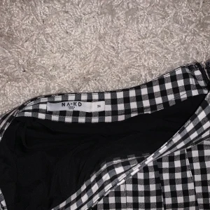 Svartvit rutig kjol - Svartvit rutig kjol från NAKD i storlek 34. Endast använd en gång.