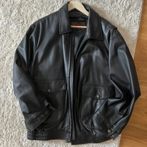 Leather bomber jacket - Danier - Black leather bomber jacket. Brand is danier. Size large. In perfect condition. Also comes with a removable padded inside insert  to make the jacket warmer in winter! (Great price compared to similar danier jackets on eBay)
