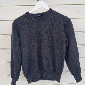 Grey Sweater - This used to be an oversized wooly sweater but then I put it in the wash and it shrank. It has a little hole in it but its basically a cropped sweater now