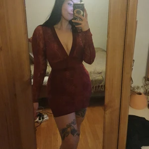 Vinröd klänning i velvet och spets  - Älskar den här, men den har tyvärr blivit för liten. Fina detaljer i velvet och spets med öppen rygg. Framhäver kroppens former galet bra samtidigt som den är bekväm och väldigt stilren! Endast använd 1-2 gånger så är i så gott som nyskick. Passar S-M. Slutsåld online! Frakt tillkommer.