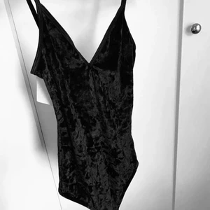 Svart body  - Säljer denna jättefina fest body i sammets material som tyvärr är för liten, prislappen sitter kvar då den är helt oanvänd 🖤