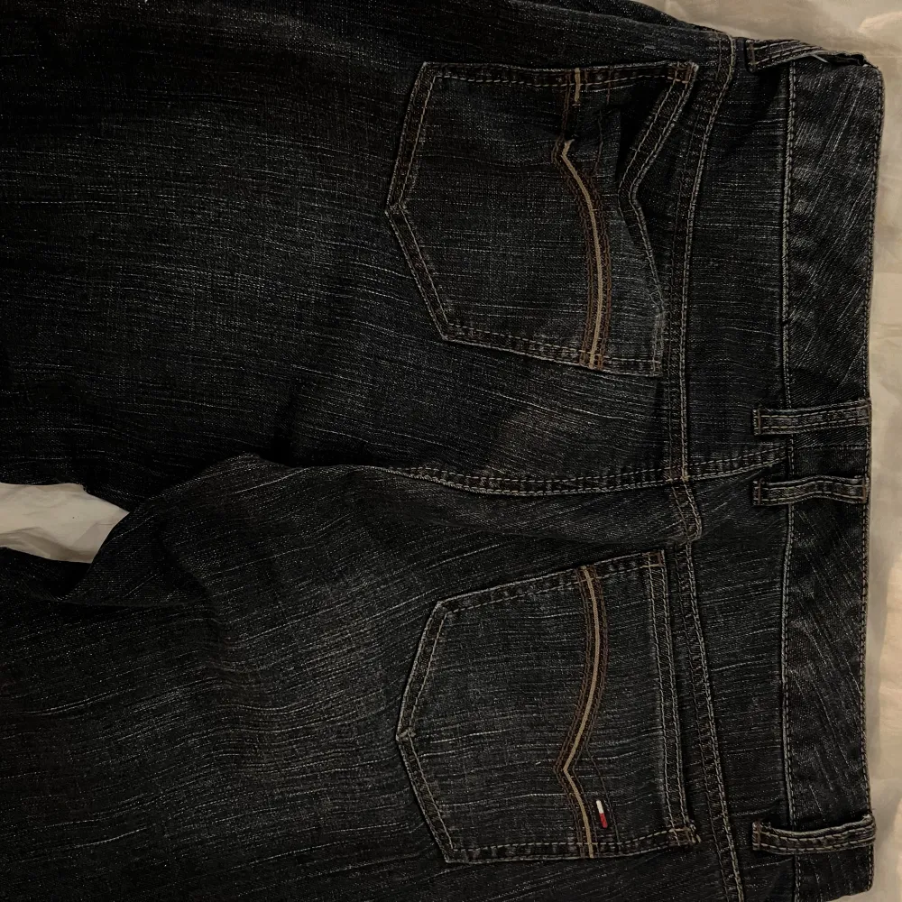 Fett snygga utsvängda mörkblå jeans från Tommy Hilfiger. Waist: 88cm, inseam: 80cm, rise: 24cm. Se bild 3, ihopsytt vid bakfickan. Köp nu funkar bra, hör av er vid frågor! . Jeans & Byxor.