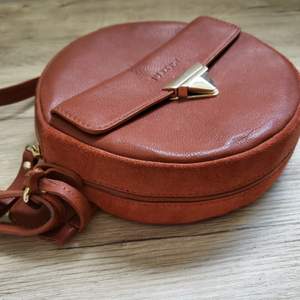 Natural high quality leather purse. It is brown and has not been used.  Brand: burkely