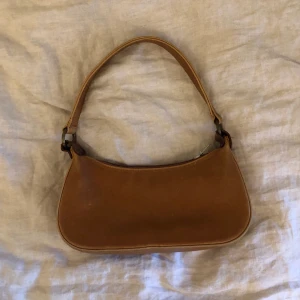 Liten brun väska  - Liten baguetteväska köpt secondhand. Kan mötas upp i stockholm.