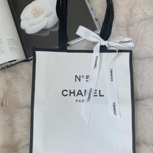 Chanel parfums No 5 GIFT SHOPPING BAG/ vit tygväska  - Observera att denna produkt inte säljs i butiker.  Den är en gåva när man köper från Chanels skönhetsbutik. Produkt från en personlig samling. 100% helt ny och äkta. Längd: 35,5 cm  Bredd: ca 30cm Chanel bandet följer med väskan. DM för flera bilder. 