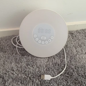 Clock - An alarm clock that works as a radio and has multiple coloque settings (white light, green, red, dark blue, purple, orange, light blue) *plus shipping*