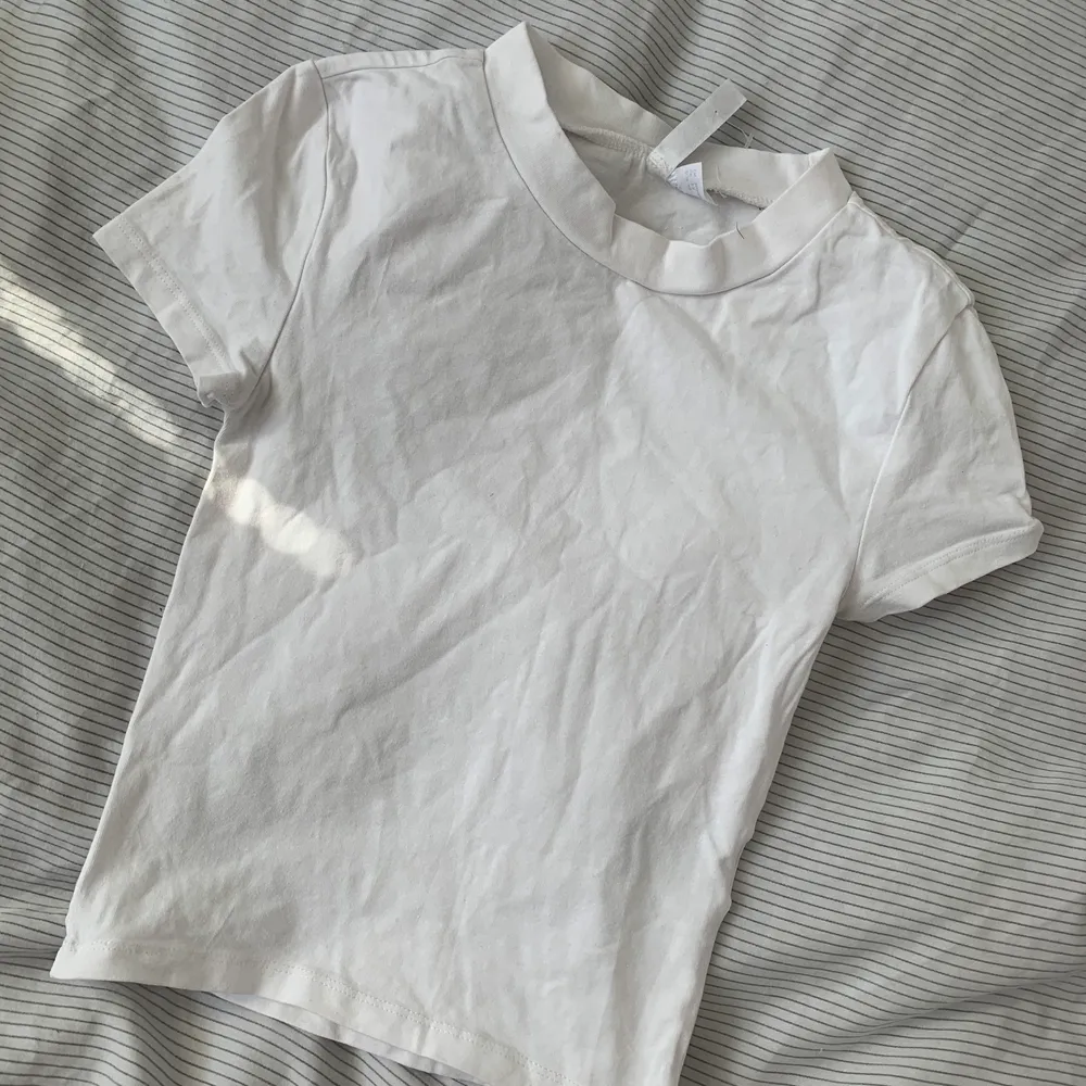 Vit t-shirt i skönt material som ger snygg passform - tajt, stretchig och cropped. T-shirts.