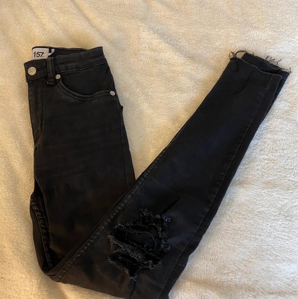 Skit snygga svarta högmidjade jeans från Lager157, slitna vid knäna och lite nere vid fötterna(i modell ). Dom är i jätte bra skick.💕. Jeans & Byxor.