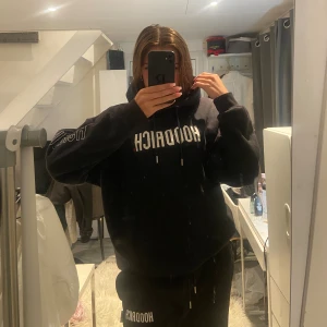 Svart hoodrich tracksuit - Svart hoodrich tracksuit i strl M men passar även mig som vanligtvis har S. Nypris 1190kr. Har en dragkedja med en ficka i ärmen och byxorna har en ficka på ett av byx benen. Sparsamt använda utan några defekter.
