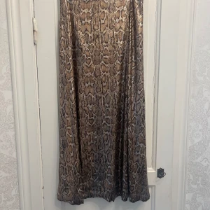 Långkjol med paljetter och ormmönster  - Långkjol med paljetter och ormmönster i S