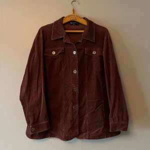 Perfekt manchester-skjorta!! - Underbar brun manchester-skjorta med metallknappar. Storlek M/L, jag som haft den har burit den som oversize. Är typ lite A-formad, toppenfin 🌸