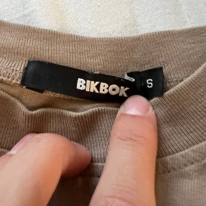 Bikbok magtröja (ljusbrun) - Det är en väldigt söt liten magtröja från bikbok, den är ljusbrun och det ser ut som att man har klippt den vid magen💗💗 säljer den för att jag inte tycker om magtröjor längre💗💗